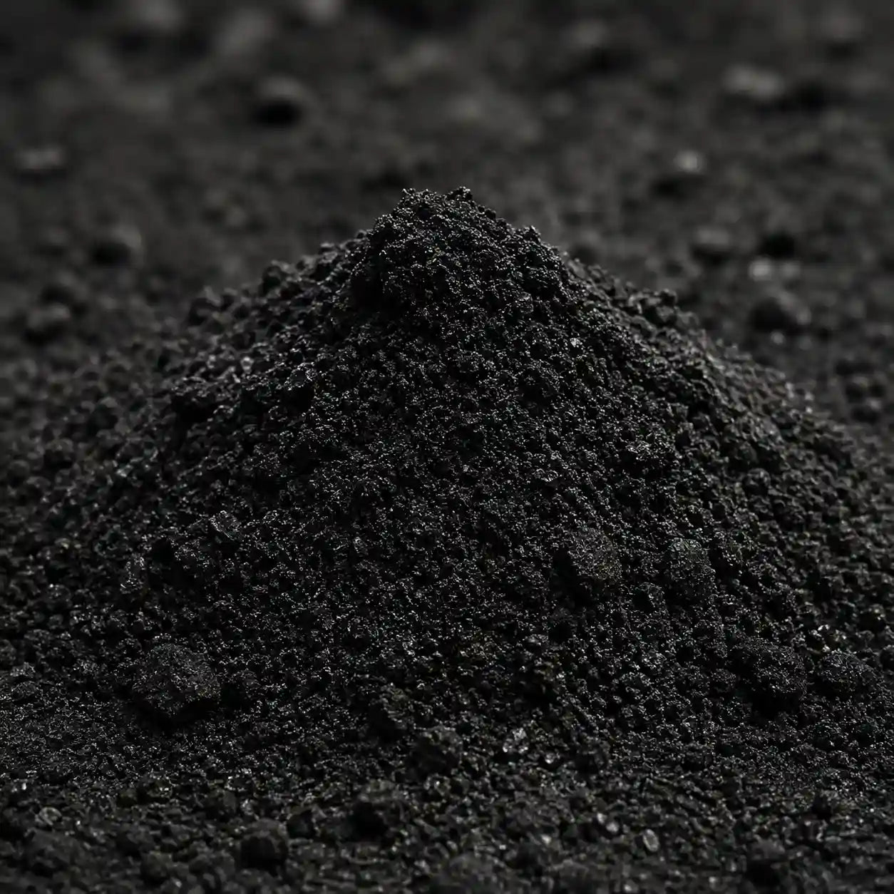 Close-up of a pile of dark soil or compost